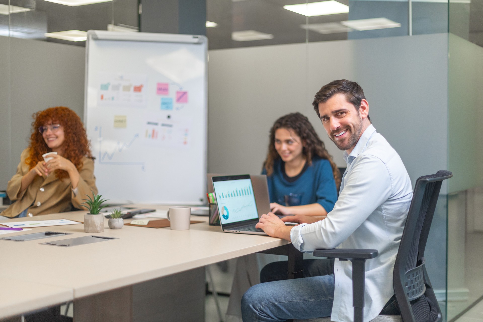 Marketing professionals working on laptops in modern office